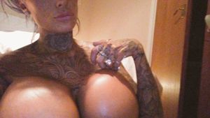 What catches the eye are her tattoos...no, her huge breasts... no, her tattoos... no, her huge breasts... no, her tattoos...