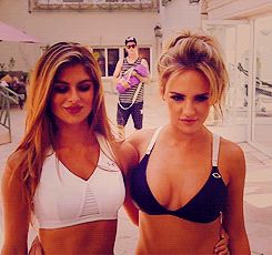 2 women touching each others asses while walking gif