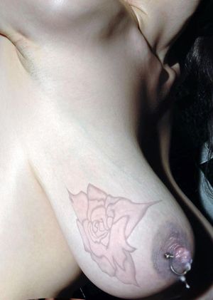 em56: The perfect tit: tattooed, pierced, ringed and producing...
