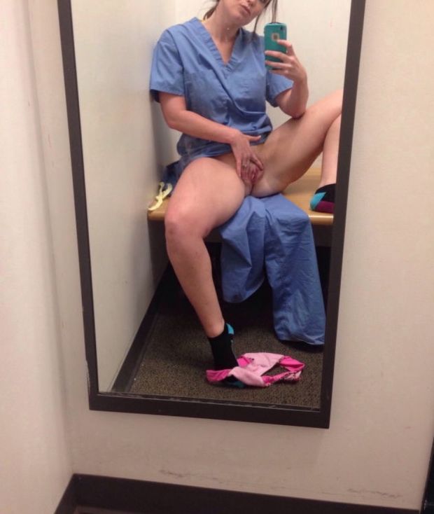 In mirror taking pussy selfie at work