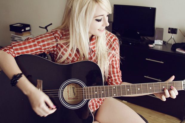 nude pic of a sexy blonde playing guitar