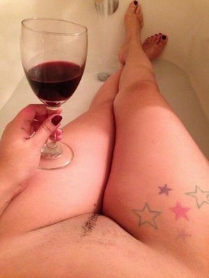 nude in tube drinking wine