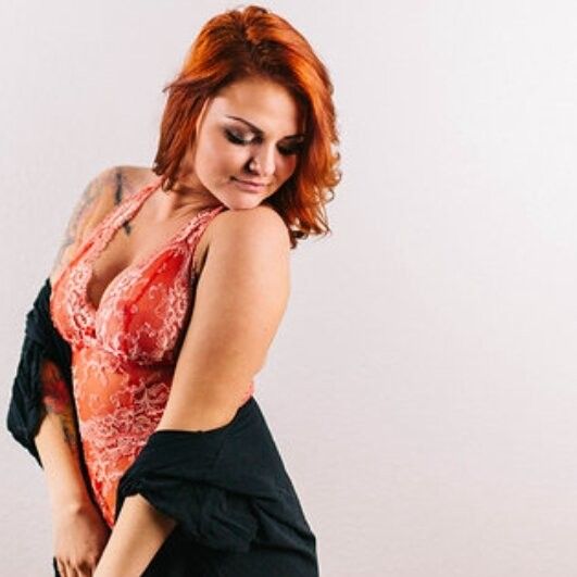 Petite redhead model with big tits