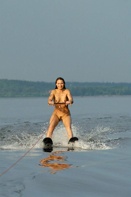 She's naked on water skis, having fun.