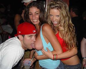 Miss Nevada having some help from her friend to let a guy suck her tits.