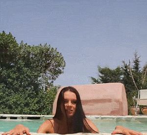 She's in and out of the water in the pool. very sexy.