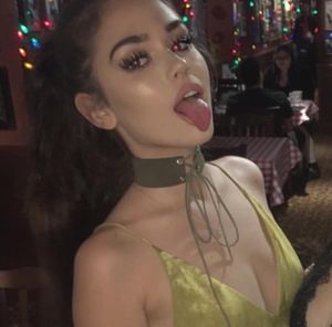 sexy chick with a choker sticks her tongue out