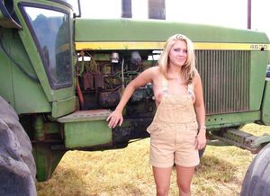 With the tractor with her tits coming out of her overalls