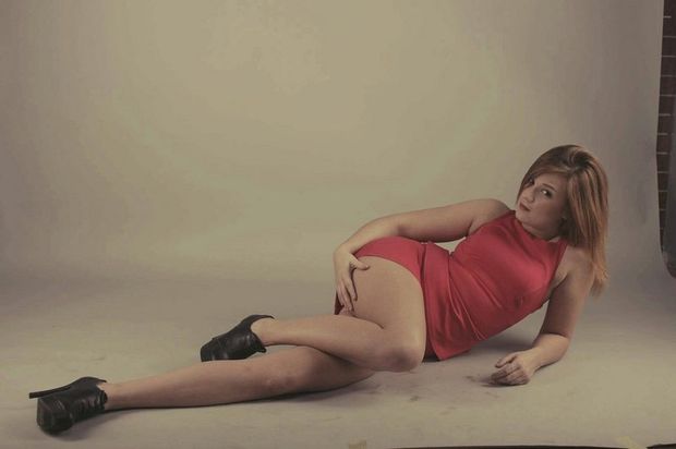 Redhead chick in red mini dress and black ankle boots