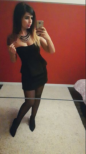 Busty brunette in tight strapless mini dress