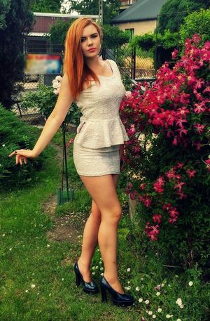 Really hot redhead chick in tight sexy mini dress posing outdoors