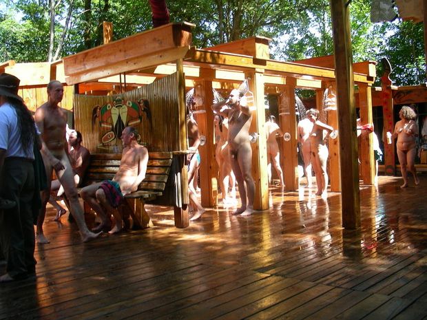 nudists rinse off in public outdoor showers