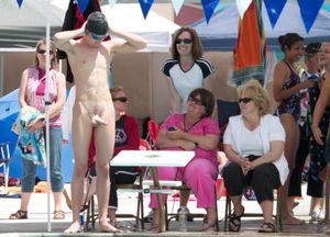 naked swimmer in front of many women
