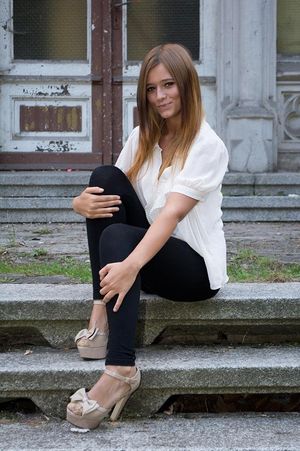 Nice rookie posing outdoors in tight black pants, high heels and white blouse