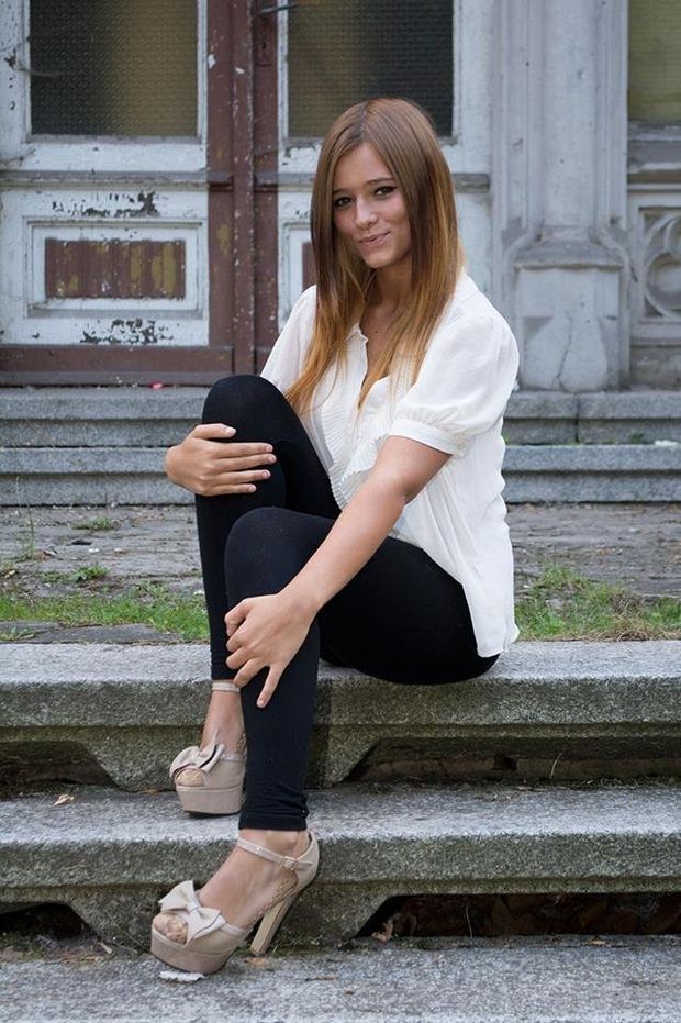 Nice rookie posing outdoors in tight black pants, high heels and white blouse