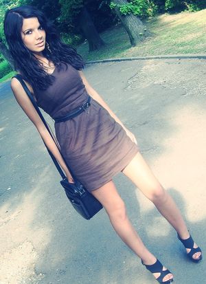 Pretty damn good dark hair chick posing outdoors in tigh mini dress and heels