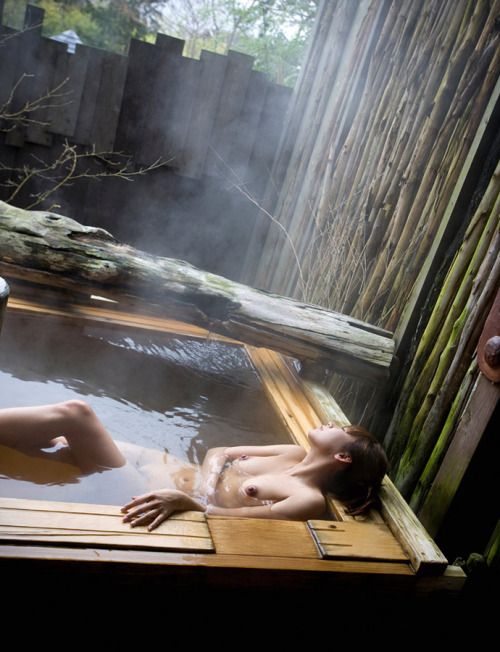 Japanese Woman Relaxing In Onsen Bath With Breasts Bobbing