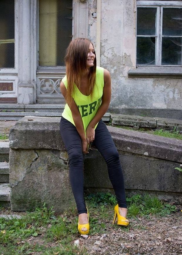 Brunette chick posing outoors near abandoned building