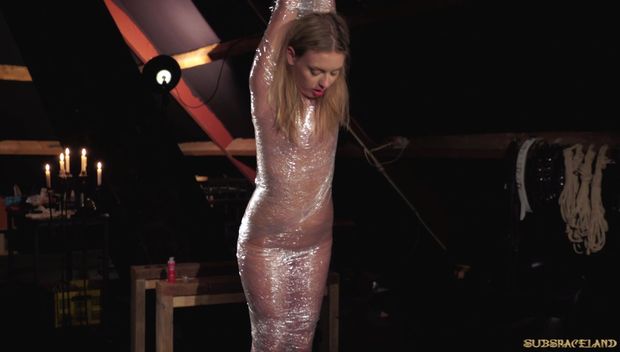 Blonde Danielle Soul sex slave getting mummified in plastic film in the lates update from Subspaceland!