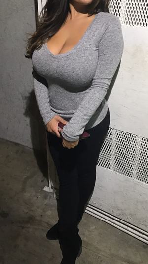 Busty dark haired babe in grey sweater and yoga pants