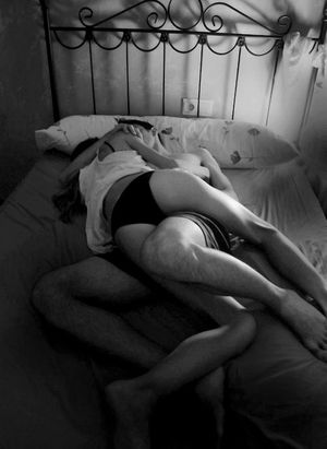 Couple cuddling in bed