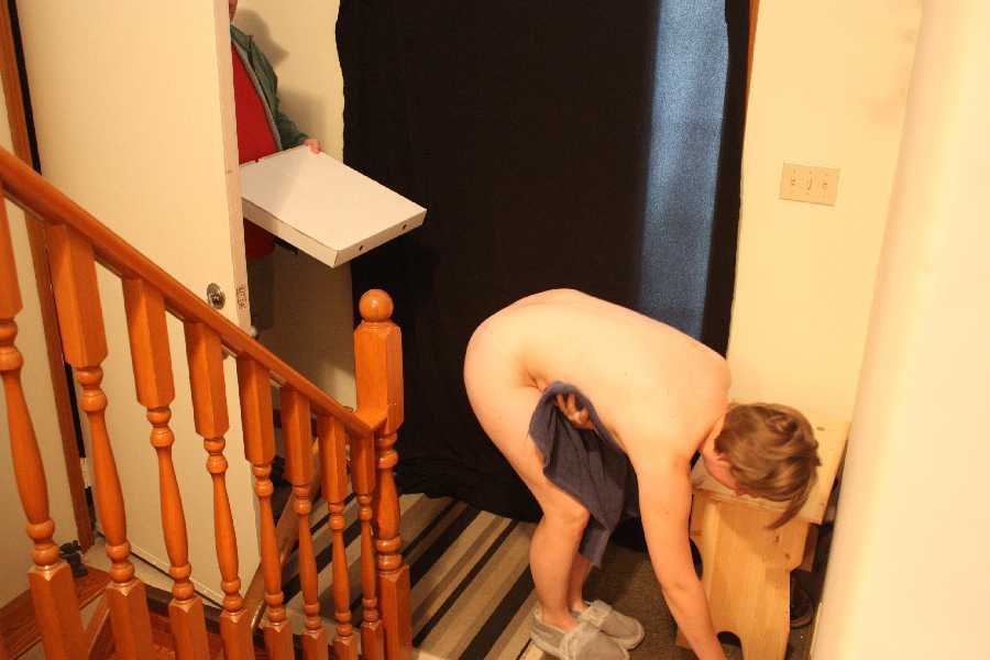 Wife Kirven shows the pizza guy the package from the rear.