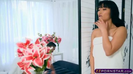 Exotic asian chick oiled up and fucks on a massage table