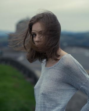 art photo, woman with poky nipples standing in wind