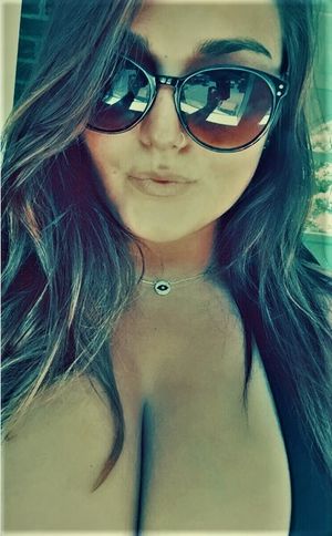 Busty amateur taking a selfie of her cleavage