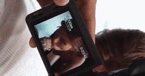 Redhead giving a blowjob while being recorded with a cell phone