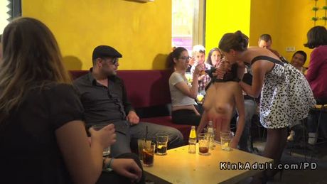 Brunette sub serving crowd in public bar