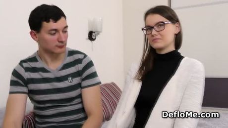 Teenie with glasses is losing her virginity in front of a camera
