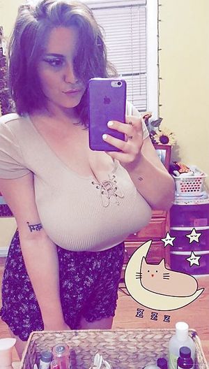 Hot amateur brunette with huge tits and cleavage