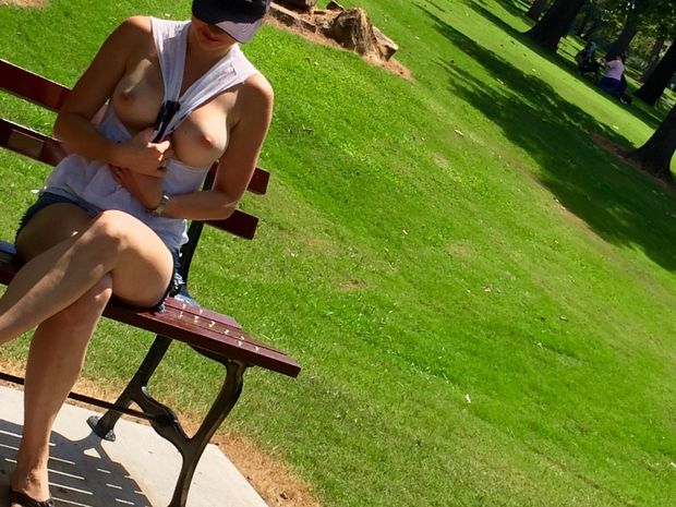 Flashing her hot tits in public park