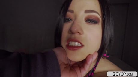 Pornstar babe Taissia Shanti wears a tight pink leggings and sparkly heels. She curves her butt on a chair in a dark room.