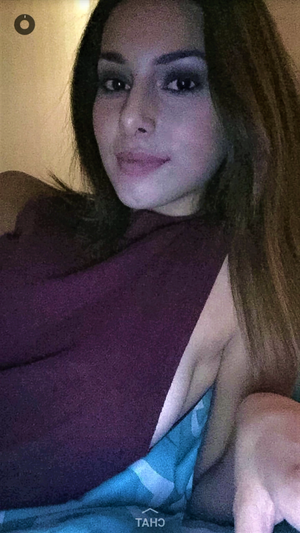 cute face slut laying on bed with no bra