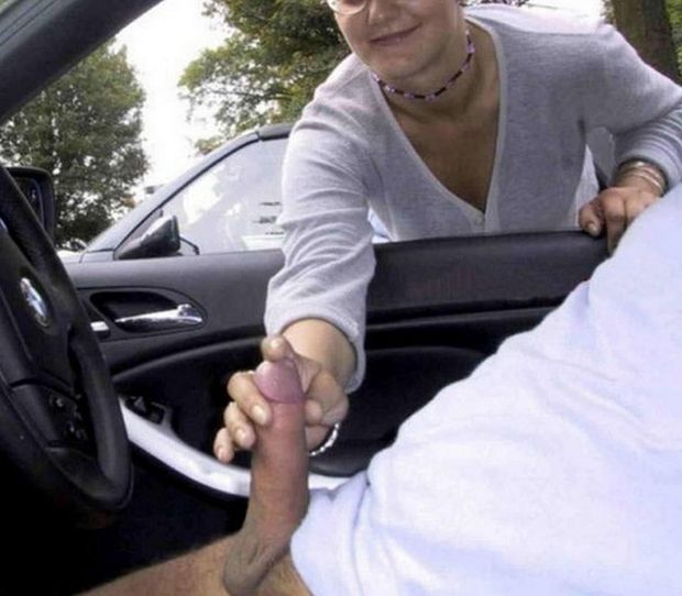 Mature lady gives handjob to dude in his BMW.