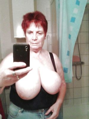Redhead grandmother boasts big boobs in mirror selfie