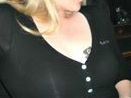 blonde hotwife casually displaying queen of spades at club