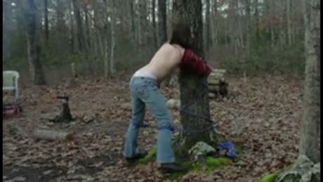 helpless tied to a tree