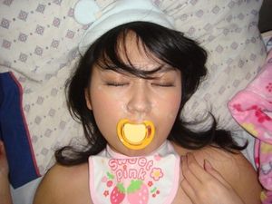 Cute asian baby napping with pacifier.