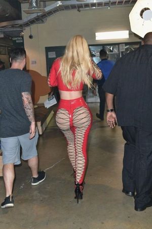 blonde in red showing ass through fishnet see-through