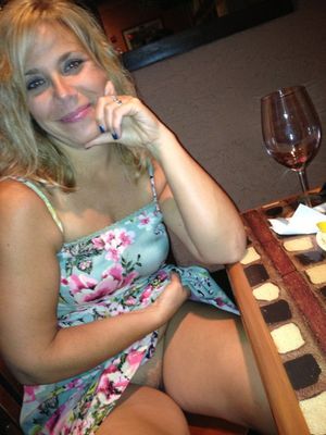 Milf pulls up her skirt at a restaurant