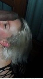 blonde with black cock resting on her face