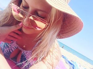 Blonde babe with big tits on the beach