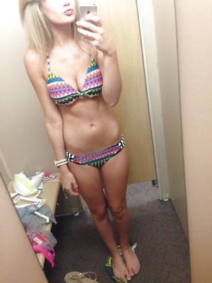 Checking out her hot body in a new bikini in the changing room