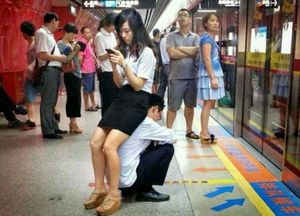 wife sits on husband in public