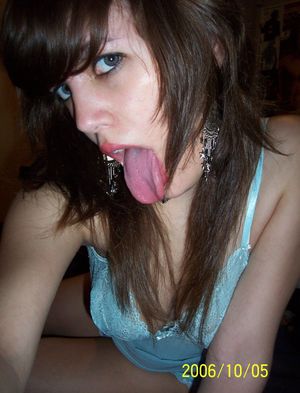 Sexy emo brunette in baby blue lingerie sticks her tongue out