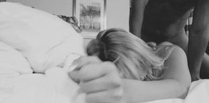 Sitting on her - fucking her from behind, while she buries her face in the pillow.