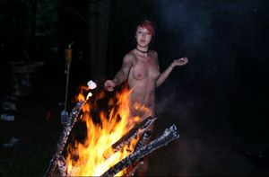 Scene chick fully nude during the evening campfire